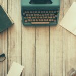 Vintage typewriter on desk with glasses and book — symbolic of faith-filled writing.